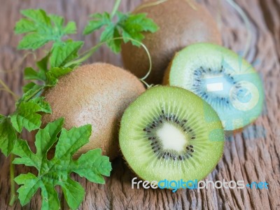 Kiwi Fresh Fruit With Leaf On Old Wood Background Stock Photo