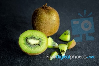 Kiwi Fruit On Black Stone Low Key Light Stock Photo