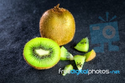 Kiwi Fruit On Black Stone Low Key Light Stock Photo