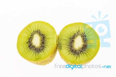 Kiwi Slices Into Half On White Background Stock Photo