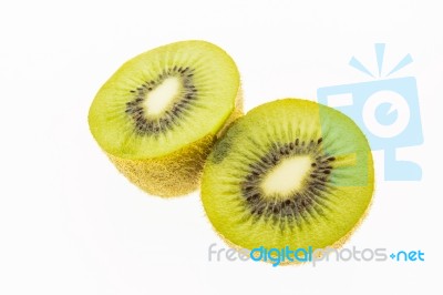 Kiwi Slices Into Half On White Background Stock Photo