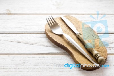 Knife And Fork On Wooden Background Stock Photo