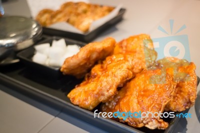 Korean Fried Chicken On Black Plate Stock Photo