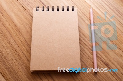 Kraft Cover Notebook On Wood Table Stock Photo