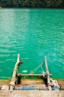 Ladder Made Of Wood Into The Water Stock Photo