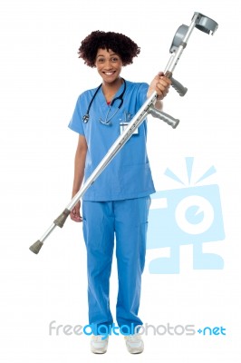 Lady Doctor Handing Over Crutches To The Patient Stock Photo