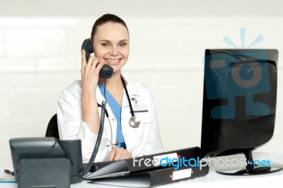 Lady Doctor Talking Over Phone Stock Photo