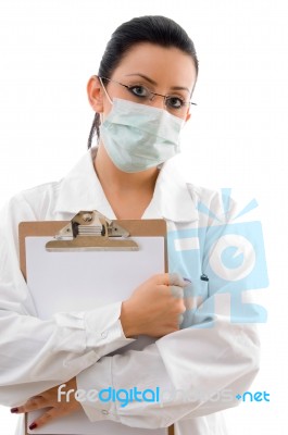 Lady Doctor With clipboard And Mask Stock Photo