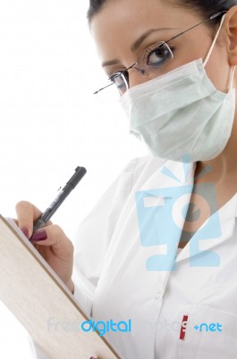 Lady Doctor With Pad And Mask Stock Photo