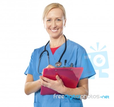 Lady Doctor Writing On Clipboard Stock Photo