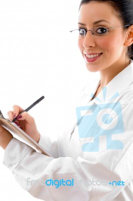 Lady Doctor Writing On Clipboard Stock Photo