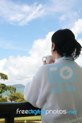 Lady Drinking Coffee In Balcony Stock Photo