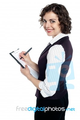 Lady In Waist Coat Taking Down Instructions Stock Photo