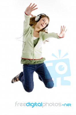 Lady Jumping While Listening Music Stock Photo