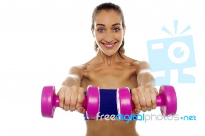 Lady Lifting Dumbbells, Arms Outstretched Stock Photo