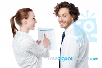 Lady Pointing At Statistics Given On Report Stock Photo