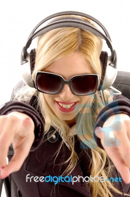 Lady Pointing Forward With Earphone Stock Photo