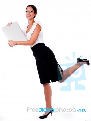 Lady Raising Her Leg With Laptop Stock Photo