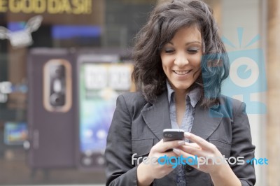 Lady Reading Sms In Street Stock Photo