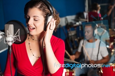 Lady Singing In Recording Studio Stock Photo