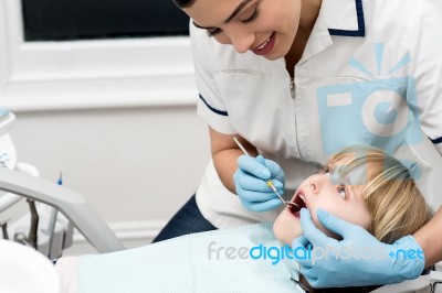 Lady Stomatologist Checking Childs Teeth Stock Photo