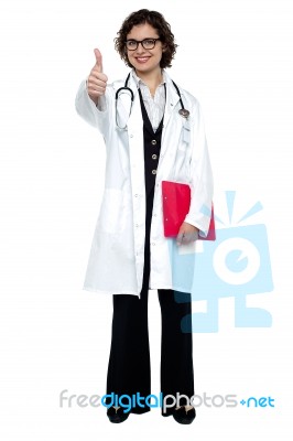 Lady Surgeon Gesturing Thumbs Up Stock Photo