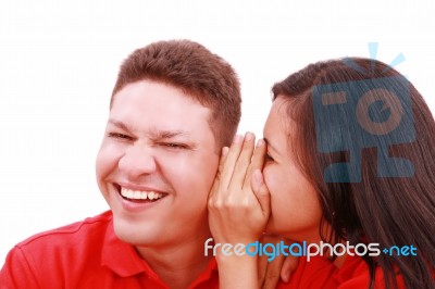 Lady Telling Secret To Man Stock Photo