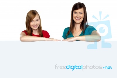 Lady With Daughter Posing Behind Blank Billboard Stock Photo