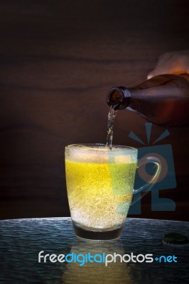 Lager Beer Drain From Bottle To Glass On Table Stock Photo