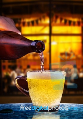 Lager Beer Drain From Bottle To Glass On Table With Beautiful Li… Stock Photo