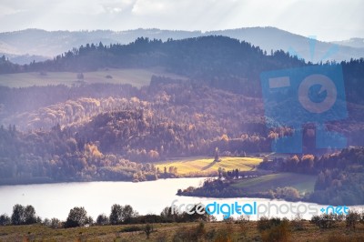 Lake Behind Foothills Of Tatra Mountains. Autumn Sunset Stock Photo