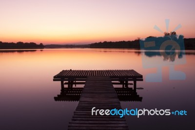 Lake Pier At Sunset Stock Photo