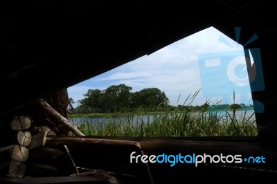 Lakeside Through A Wooden Window Stock Photo