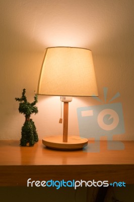 Lamp On The Desk With Reindeer Tree Decoration Stock Photo