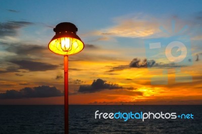 Lamp With Sunset In The Sea Stock Photo