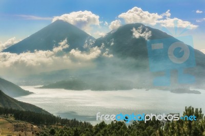 Landscape Of Volcanoes Surrounding Lake Atitlan In Guatemala Stock Photo