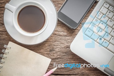 Laptop And A Cup Of Coffee With A Smartphone On Old Wooden Background. Working In The Morning Concept Stock Photo