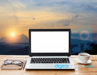 Laptop And Coffee On Workspace And Mountain At Sunset Background… Stock Photo