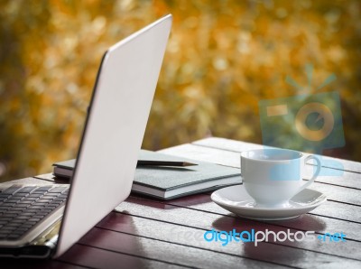 Laptop And Cup Of Coffee On Desk Stock Photo