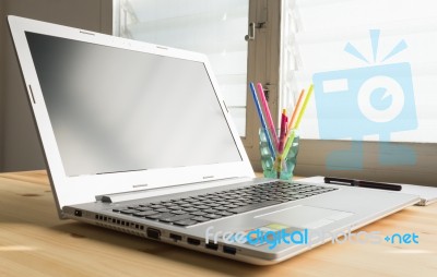 Laptop And Notebook And Pen On Wood Table Stock Photo