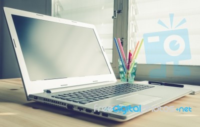 Laptop And Notebook And Pen On Wood Table On Blue Vintage Style Stock Photo