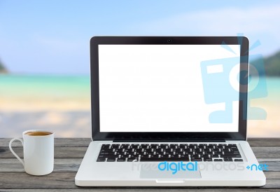 Laptop Computer And Coffee Cup Front Angle On Beach View Stock Photo