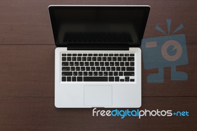 Laptop Computer On Wood Desk Top View Stock Photo