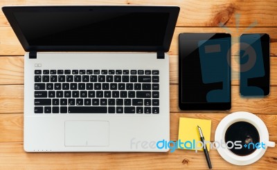 Laptop Computer Tablet Phone And Coffee Drink On Wood Workspace Stock Photo