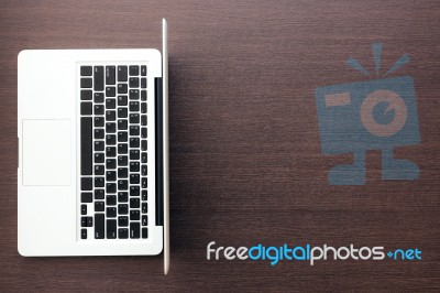 Laptop Computer With Blank Space On Wood Desk Top View Stock Photo