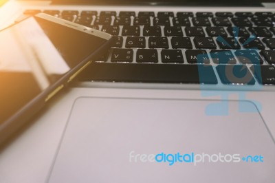 Laptop On The Desk With Mobile Phone Stock Photo