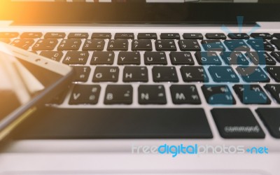 Laptop On The Desk With Mobile Phone Stock Photo