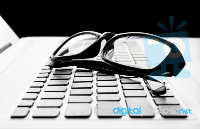 Laptop Or Notebook Button And Black Glasses  On Black Background… Stock Photo