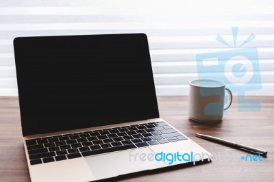 Laptop With Blank Screen On Table Stock Photo