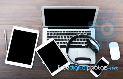 Laptop With Tablet And Smart Phone On Table Stock Photo